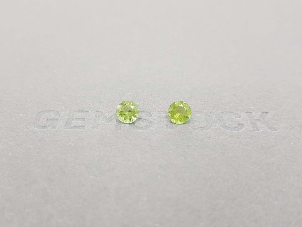 A pair of bright green tourmalines in a 5 mm round cut Image №1